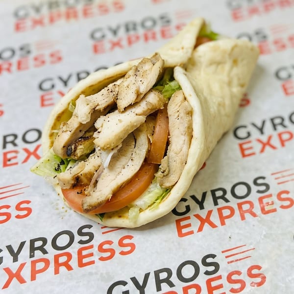 Chicken Gyro Express pita with grilled chicken, lettuce, and tomato on branded paper.